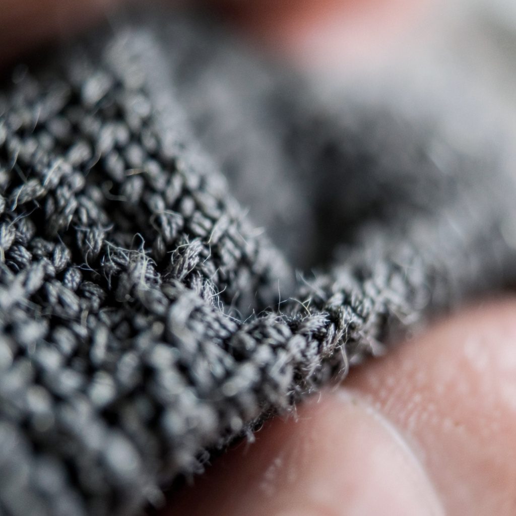 Extreme close-up of aged paper texture with soft warm tones, evoking old school archives and memories